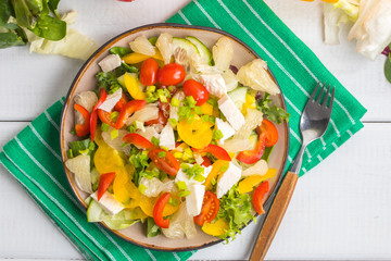 Salad with cheese and fresh vegetables.