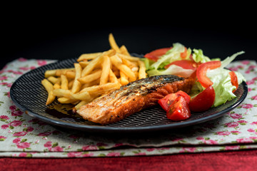 Grilled Salmon with fresh lettuce and Golden French fries