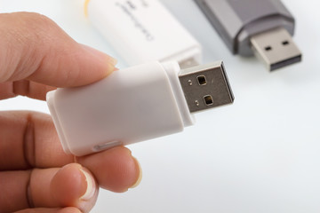hand holding usb flash, usb memory stick on white.