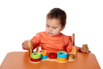 Child little girl learning to use colorful logic game isolated on white background