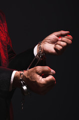 Magician shows trick with chains. Manipulation with props. Sleight of hand.