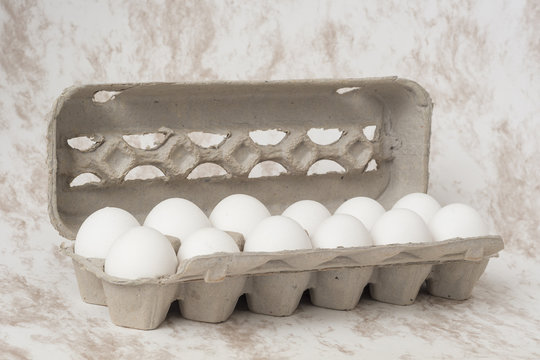 Caja de huevo semiabierta con fondo de marmol