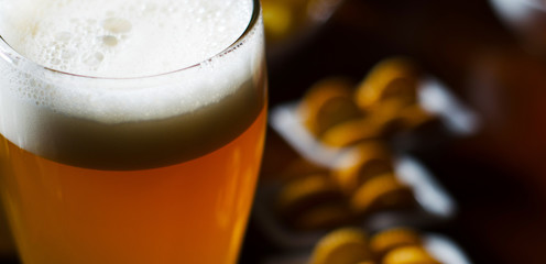 pint of lager beer in a glass, set of various snacks, a standard set of drinking and eating in a pub