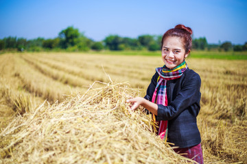 Naklejka na ściany i meble farmer woman relaxing with the straw in field
