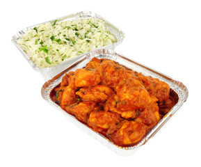 Chicken curry take away meal with rice in foil containers isolated on a white background