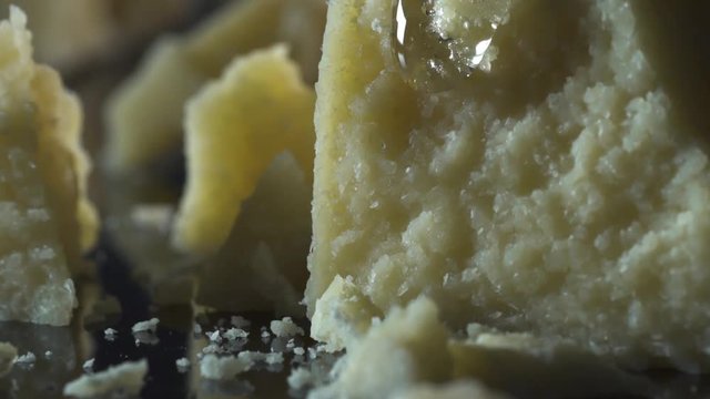 honey dropped on grana parmesan cheese