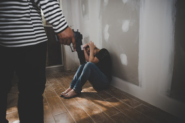 The girl was stripped by thieves in black and white shirt with a gun in hand at abandoned house
