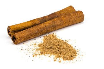 Cinnamon sticks and powder on white background