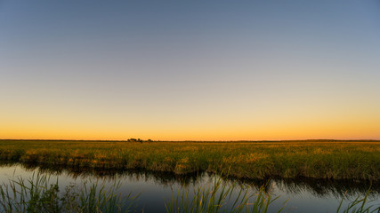 USA, Florida, Glowing orange sky over everglades nature landscape after sunset