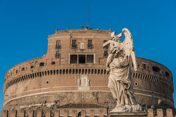 Statue of angel with cross, Saint Angelo castle on background