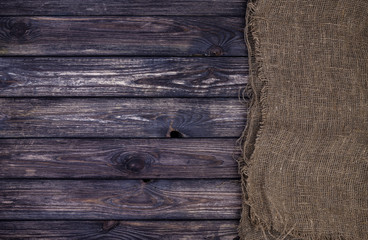 Dark wooden texture with burlap, wood and sack