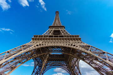 Fototapeta na wymiar The Eiffel Tower bottom view over blue sky