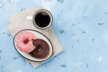 Coffee cup and colorful donuts