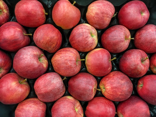 Ripe red apples stacked in a box
