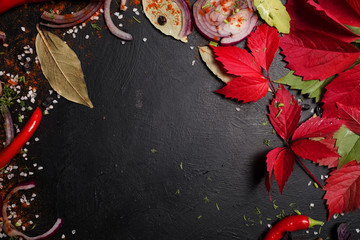 Obraz na płótnie Canvas autumnal kitchen veggies pieces negative space concept. food ingredients on dark background. vegan lifestyle