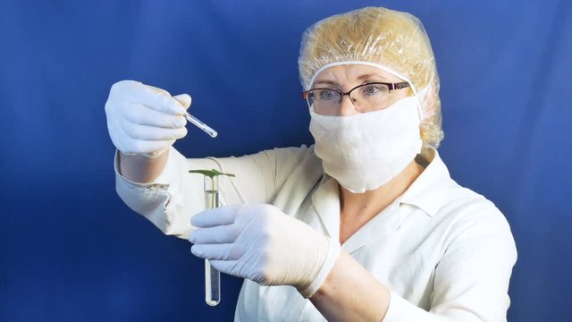 Medical worker with tube and green leaf. 