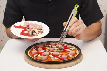 man is cooking pizza