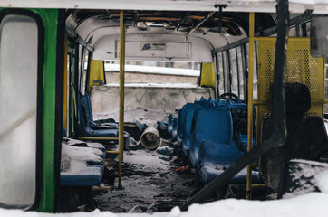 The abandoned passenger bus after the explosion. Inside, you can see broken armchairs and broken...