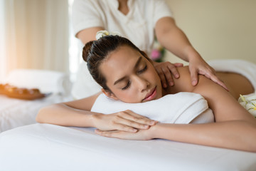 Young beautiful Asian woman relaxing in the spa massage