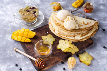 Preparing for pancakes with tea and honey