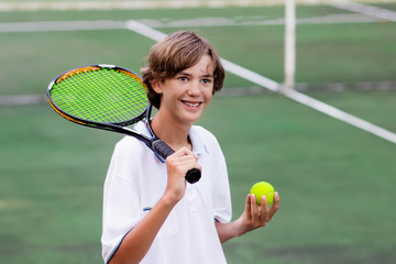 Child playing tennis on outdoor court © famveldman