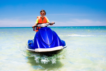 Teenager on jet ski. Teen age boy water skiing.