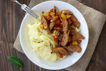 Soy meat with potato puree over kitchen table.