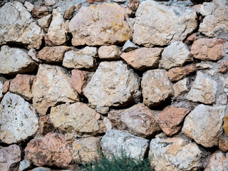 Old stone drywall. a wall of wild natural stone background texture