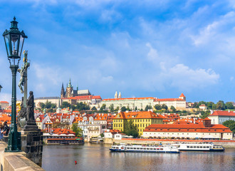 Fototapeta premium Prague Castle. The Charles Bridge. Medieval fortress. The Vltava River. Cathedral of St. Mikulas. Red tiled roofs
