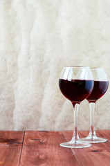 Two glasses of wine on a wooden table