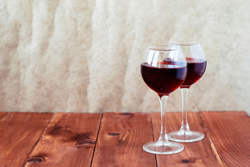 Two glasses of wine on a wooden table
