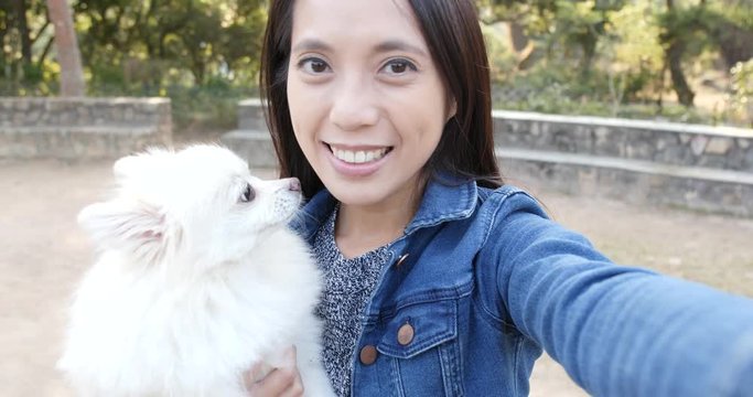 Woman taking photo selfie with her dog