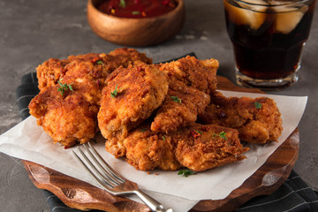 Chicken nuggets, ketchup sauce and on black wooden background. 