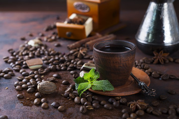Coffee in cup and mint leaves on dark stone table. © YuliiaMazurkevych