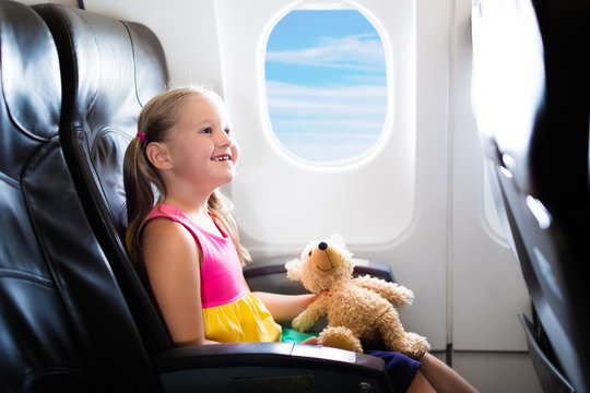 Child in airplane. Flight with kids. Family flying.