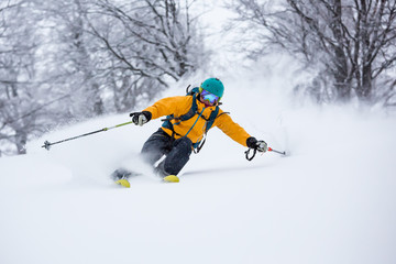  A skiier is riding down the hill. Freeriding in Carpathian mountains.