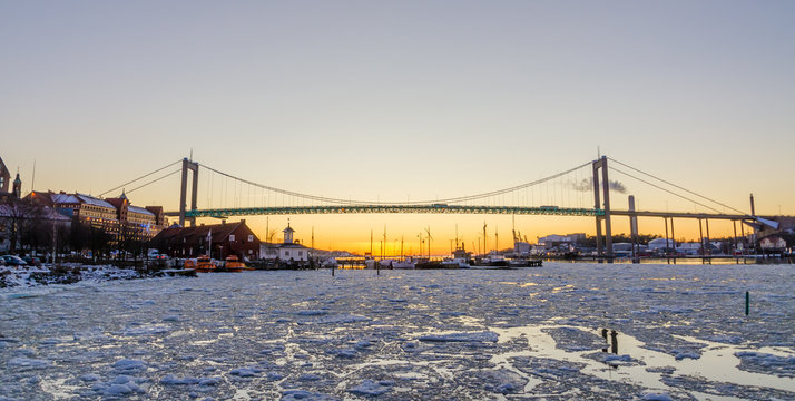 Gothenburg - Beautiful sunset at frozen Gota river with Hisingsleden Bridge in the harbor district during winter