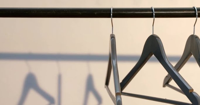 Hangers arranged on clothes rack  