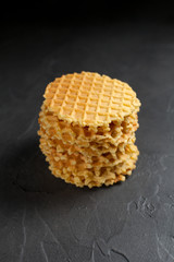 round fresh waffle pile on a dark background