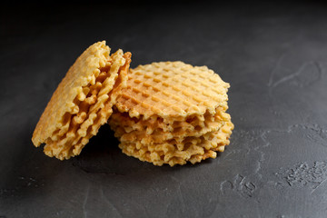 round fresh waffle pile on a dark background