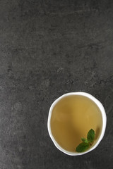 Obraz na płótnie Canvas Fresh mint leaves in tea. Italian herbs. Dark background.