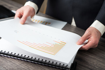 Business man checking bar chart