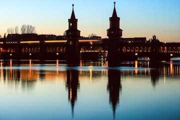 Oberbaum bridge over spree river at twilight in Berlin, Germany