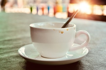 Dirty cup of coffee on table in cafe ,Morning light