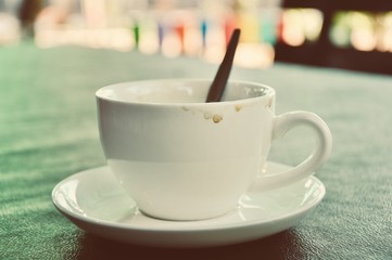 Dirty cup of coffee on table in cafe ,Morning light
