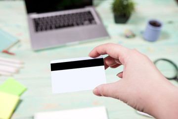 Business and finance concept. Hand hold blank credit cards with wood table office background