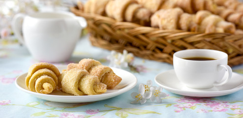 Many croissants on a table with spring flowers