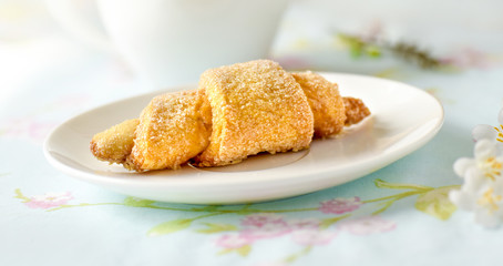 Many croissants on a table with spring flowers