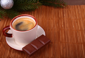 Coffee cup and chocolate on wooden table texture. Coffeebreak. Christmas time
