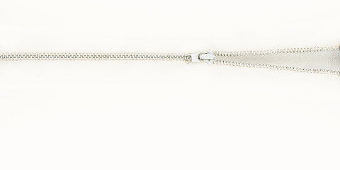 A zipper opening on a bright white background with lots of negative space.